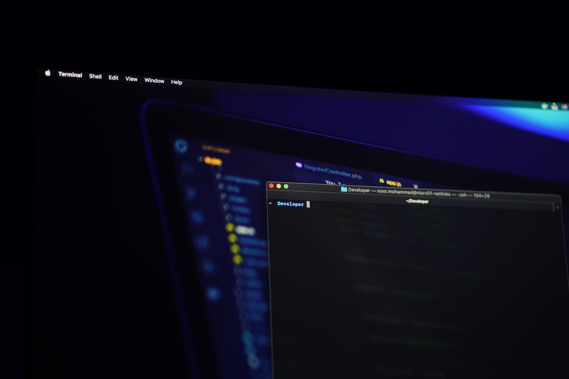Developer workspace glowing in a dark room